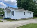 Exterior view of the property with white siding, showing the driveway and backyard at 703 W Church St, Angier, NC 27501