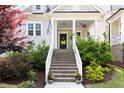 Inviting front entrance with landscaped staircase, flower pots, and a welcoming front door at 706 Great Ridge Pkwy, Chapel Hill, NC 27516