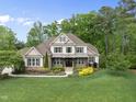 Beautiful home with well-maintained lawn and landscaping set among mature trees at 7312 Hasentree Way, Wake Forest, NC 27587