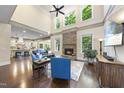 Bright, open living room with a stone fireplace and soaring ceilings at 7312 Hasentree Way, Wake Forest, NC 27587