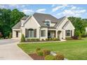 Charming two-story white brick home featuring manicured landscaping and a welcoming front porch at 8017 Discovery Falls Trl, Wake Forest, NC 27587