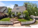 Charming home with a picket fence, landscaped lawn, and brick steps leading to the front door at 10003 Fountain, Chapel Hill, NC 27517