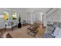 Spacious living room with hardwood floors, stylish seating, and an arched doorway leading to other rooms at 10003 Fountain, Chapel Hill, NC 27517