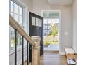 Open foyer with hardwood floors and staircase, offering a welcoming entrance into the home at 1021 Greatland Rd, Durham, NC 27703