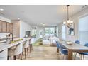 Bright open floor plan with a spacious living room featuring hardwood floors, dining, and kitchen at 1021 Greatland Rd, Durham, NC 27703