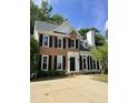 Charming two-story brick home with black shutters, well-maintained lawn, and paved driveway at 103 Romaine Ct, Cary, NC 27513