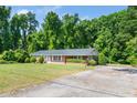 Charming single-story brick home with a well-maintained lawn and paved driveway at 1041 Davis Dr, Apex, NC 27523