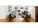 Inviting living room with a cozy fireplace, built-in shelves, and hardwood floors at 105 Sundew Ln, Cary, NC 27518