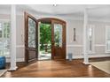 Inviting foyer featuring dark hardwood floors, a view to the fountain and elegant wall sconces at 106 Clendenen Ct, Cary, NC 27513