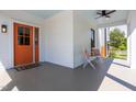 Comfortable front porch features stylish seating and an orange front door at 107 N Guthrie Ave, Durham, NC 27703