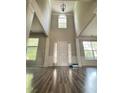 Grand foyer with soaring ceilings, wainscoting, and elegant hardwood floors at 110 Bristolwood Cir, Morrisville, NC 27560