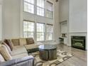 Spacious living room with a fireplace, large windows, and hardwood floors at 110 Bristolwood Cir, Morrisville, NC 27560