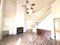 Bright, open living room with a soaring ceiling, fireplace, and hardwood floors at 110 Bristolwood Cir, Morrisville, NC 27560