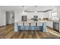 Contemporary kitchen showcasing a spacious island, stainless steel appliances, and sleek backsplash at 110 Deacon Ridge Ln, Youngsville, NC 27596