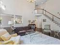 Bright living room with high ceilings, large windows, and a beautiful staircase at 112 Glenspring Way, Morrisville, NC 27560
