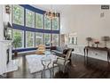 Spacious living room with tall windows, a fireplace, and a cozy seating area at 112 Glenspring Way, Morrisville, NC 27560