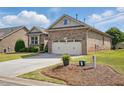 Attractive brick home, enhanced by a green lawn and a convenient two-car garage at 116 Colonade Ct, Benson, NC 27504