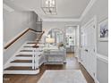 Inviting foyer with hardwood floors, staircase, and stylish décor, creating a warm welcome at 117 Queensferry Rd, Cary, NC 27511