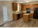 Well-equipped kitchen features ample cabinetry and modern appliances and island, perfect for culinary enthusiasts at 1208 Olympic Dr, Mebane, NC 27302
