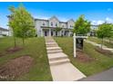 Desirable townhome showcasing a landscaped front yard, concrete steps, and a 'Home for Sale' sign at 1218 S Franklin St, Wake Forest, NC 27587