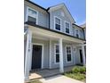 Inviting townhome with a covered entryway featuring white columns and a classic black front door at 1218 S Franklin St, Wake Forest, NC 27587