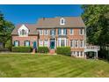 Attractive brick home with well-kept lawn and blue shutters, offering classic curb appeal at 12527 Bellstone Ln, Raleigh, NC 27614
