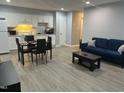 Living room with a dining room featuring white kitchen cabinets and an open floorplan at 130 S Estes Dr # C-5, Chapel Hill, NC 27514