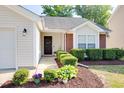 Close-up of home's entrance, showcasing a decorative wreath and manicured bushes at 1826 Heisser Ln, Fuquay Varina, NC 27526