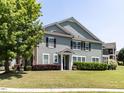 Inviting two-story home with gray siding, brown shutters, and a lush front lawn at 1909 Whirlaway Ct., Cary, NC 27519