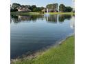 Picturesque lake reflecting surrounding homes and a water tower at 197 W Paige Wynd Dr, Angier, NC 27501