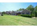 Well-manicured front yard with a charming brick home and lush green lawn at 197 W Paige Wynd Dr, Angier, NC 27501