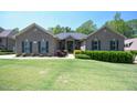 Inviting single-story home with lush lawn, mature trees, and attractive landscaping at 197 W Paige Wynd Dr, Angier, NC 27501