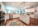 Bright kitchen featuring white cabinets, granite countertops, stainless steel appliances, and a central island at 197 W Paige Wynd Dr, Angier, NC 27501