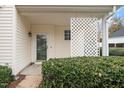 Welcoming front porch featuring a decorative lattice panel and a well-maintained shrub, hinting at a cozy entrance at 2014 Silky Dogwood Trl, Apex, NC 27502