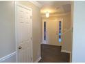 Bright entryway with hardwood floors, crown molding, and a glimpse of the outdoor view at 202 Redstone Ct, Gibsonville, NC 27249