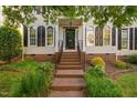 Welcoming front entrance with brick steps, black door with glass, and manicured landscaping at 210 Presidents Walk Ln, Cary, NC 27519