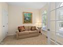 Cozy sitting room featuring a comfortable sofa, natural light, and neutral decor at 210 Presidents Walk Ln, Cary, NC 27519