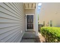 A close-up of the front door, featuring a classic design and decorative lighting at 2105 Metacomet Way, Raleigh, NC 27604