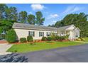 Well-manicured front yard with lush green grass, mulch beds, and manicured shrubs surrounds the home at 215 Collins Rd, Lillington, NC 27546