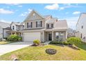 Charming home with manicured lawn, featuring a two-car garage and inviting front porch at 220 Outwater Ridge Dr, Garner, NC 27529