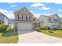 Well-kept home with two-car garage, complimented by a green lawn and blue skies at 220 Outwater Ridge Dr, Garner, NC 27529
