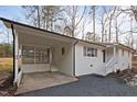 A bright exterior view of this home featuring a convenient carport and stylish front entrance at 2224 Clements Dr, Durham, NC 27704