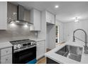 An updated kitchen with stainless steel appliances and a stylish tile backsplash at 2224 Clements Dr, Durham, NC 27704