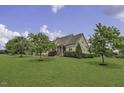 Beautiful home featuring a spacious lawn and mature trees at 25 Westbourne Ln, Youngsville, NC 27596