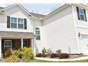 View of the side of the house with manicured shrubs and a manicured green lawn at 259 Brassfield Dr, Burlington, NC 27217