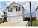 View of two-story home featuring a two-car garage, neutral siding, and black shutters at 259 Brassfield Dr, Burlington, NC 27217