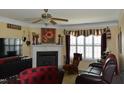 Cozy living room with a fireplace, ceiling fan, and comfortable seating at 259 Brassfield Dr, Burlington, NC 27217