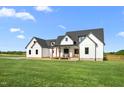 Charming two-story home boasts white siding, a black roof, and a spacious lawn at 2775 Eagles Roost Trl, Burlington, NC 27217