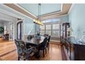 Formal dining room features elegant chandelier, wainscoting, and large window at 2820 Charleston Oaks Dr, Raleigh, NC 27614