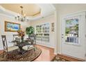 Elegant dining room featuring a decorative chandelier and views of the backyard at 3633 Willow Stone Ln, Wake Forest, NC 27587